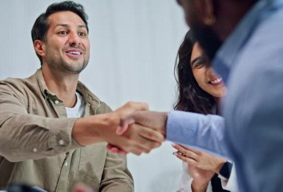 Group of business professionals meeting shaking hands after successful partnership agreement at office. Finance meeting concept.